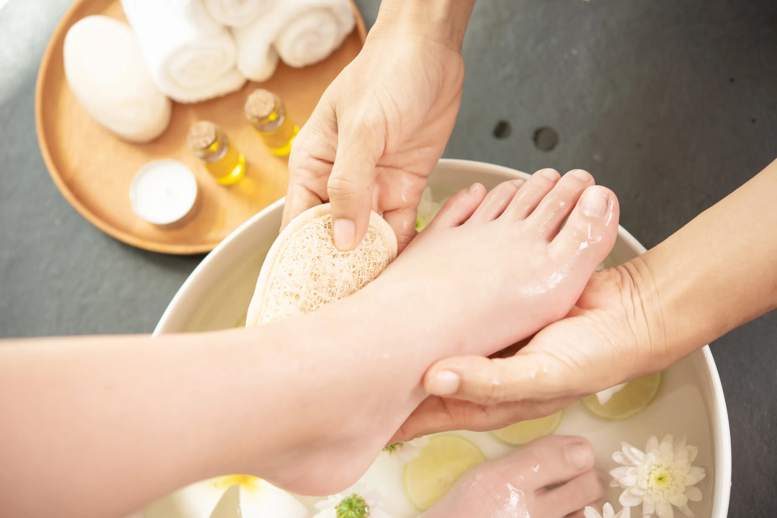 PEDIKÜRE foot washing in spa before treatment. spa treatment and product
